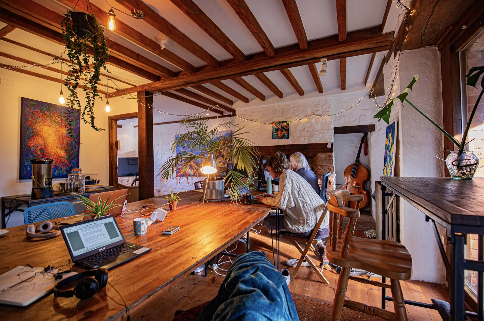 Colivers working at the long table under the beams