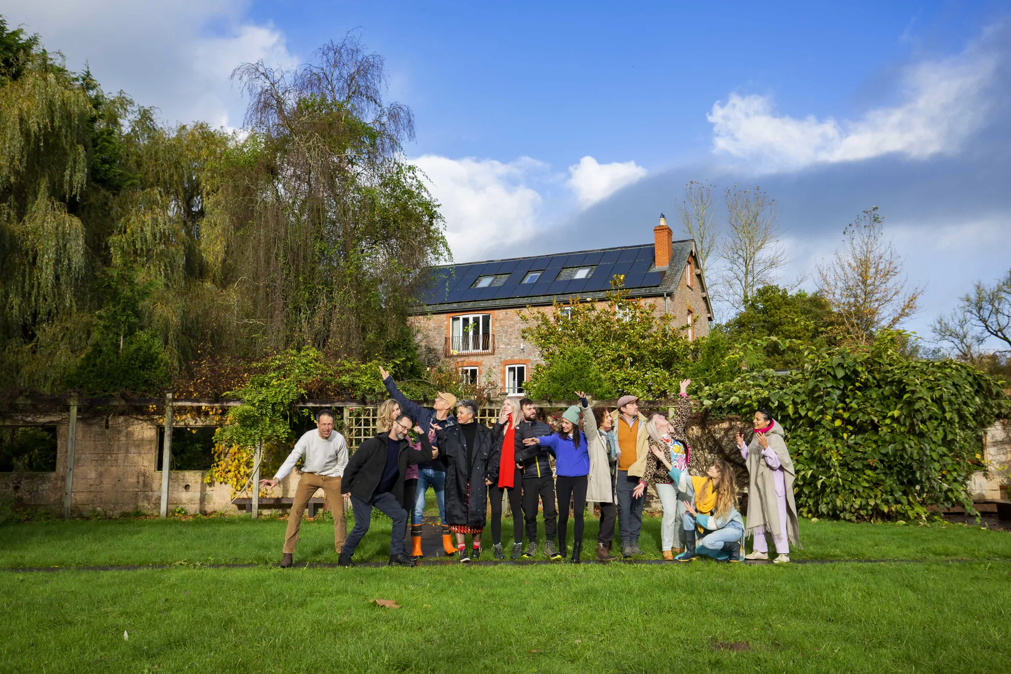 A retreat group gathered on the lawn in front of the Mill House