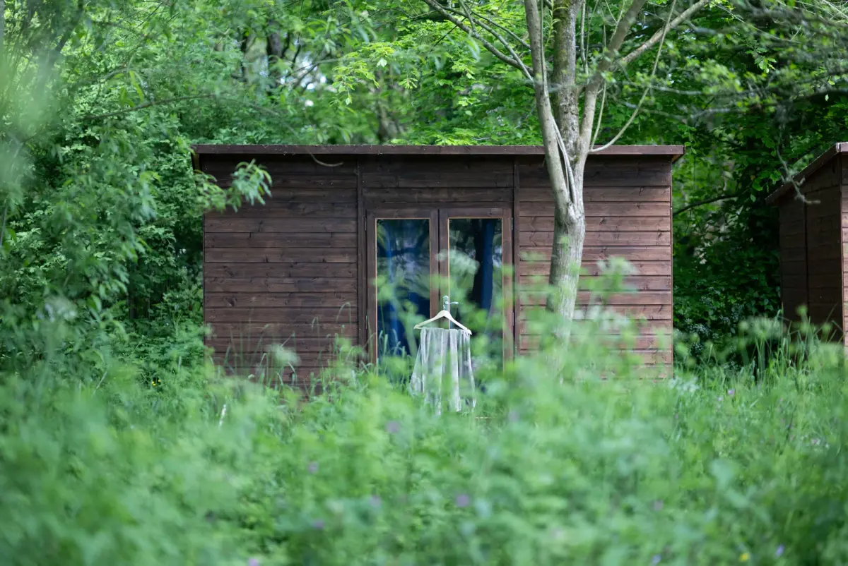 A summerhouse cabin with the woodland behind it