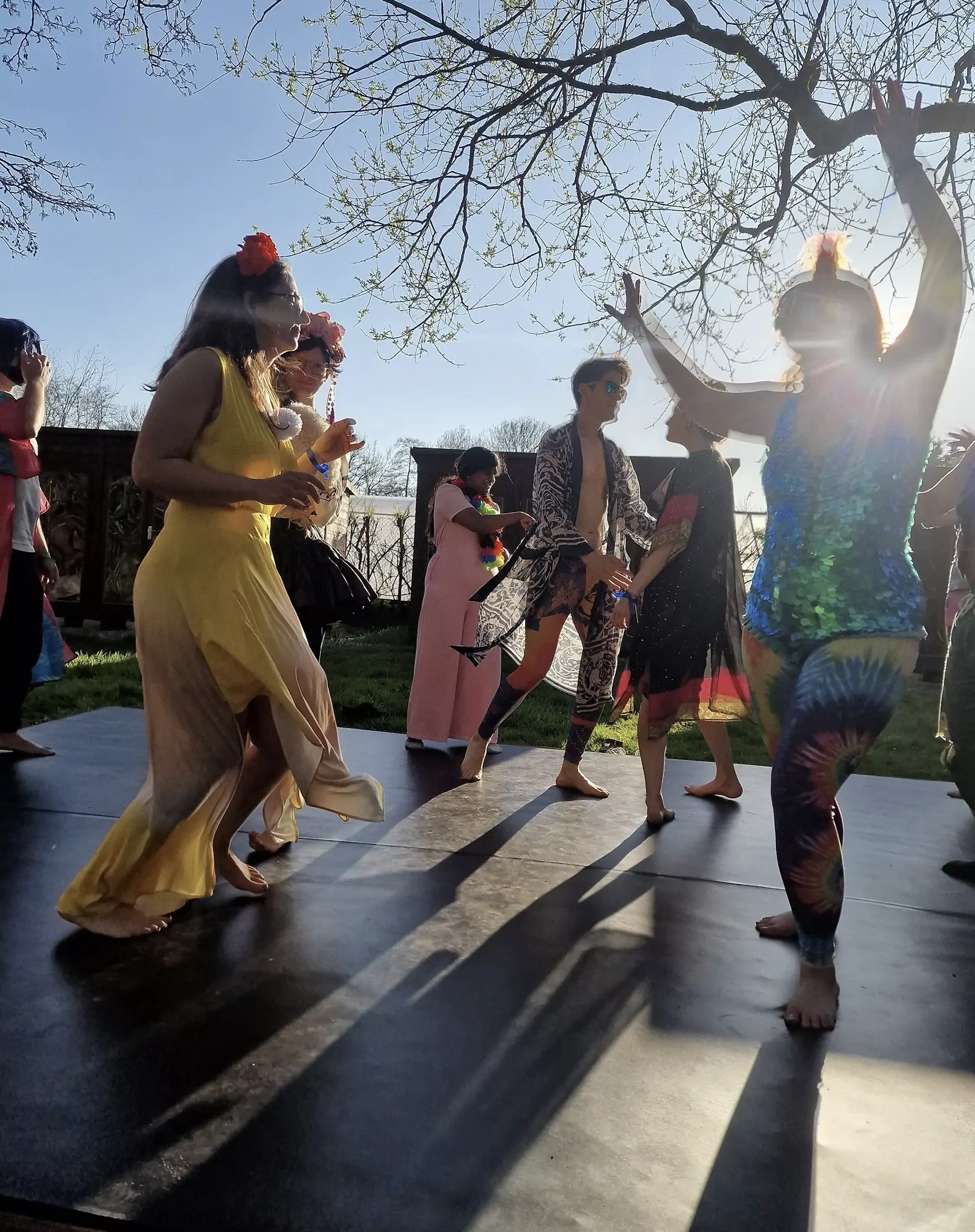 Dancing barefoot on the outdoor stage in the late spring light